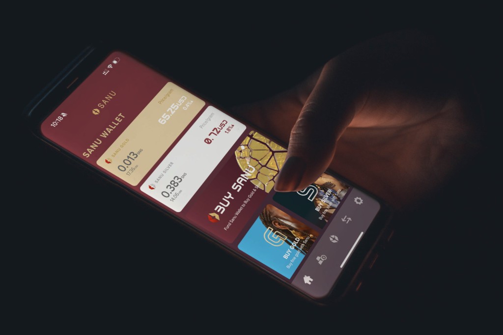 Hand holding a smartphone running the Sanu app